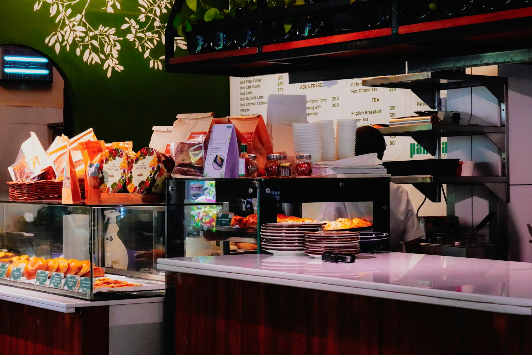 First Caffe counter with pastries, coffee bags, and warm cafe service